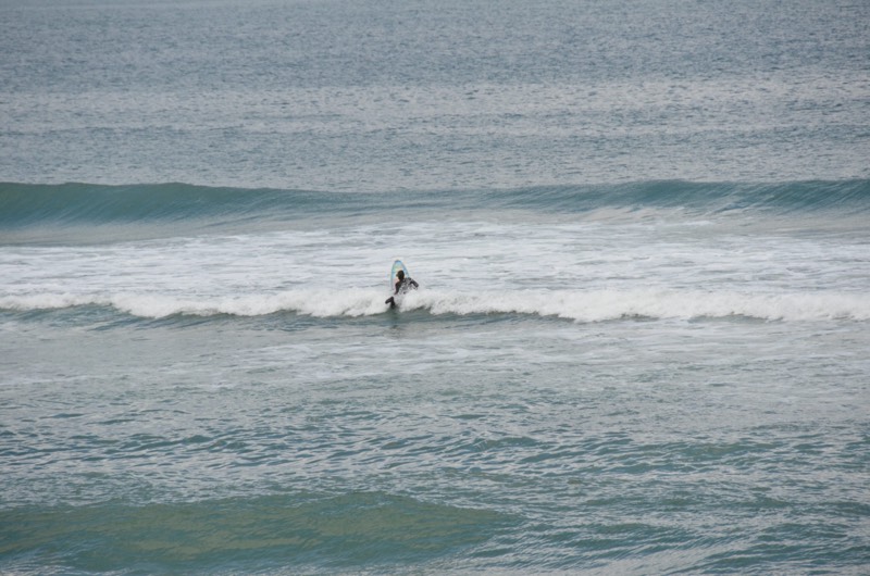 Surfer heading out at Kill Devil Hills